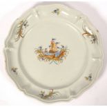 A large Continental faience dish, possibly Alcora, decorated a vignette of ships,