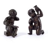 A pair of Victorian bronze putti, one reading a book, the other with a pitcher on his shoulder,