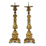 A pair of Continental gilt metal altar type candlesticks,