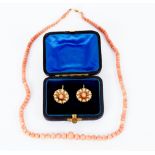 A pair of Edwardian coral and pearl earrings of flowerhead design, on French hook fixings,