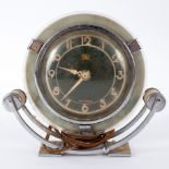 An Art Deco mantel clock by Smith, in a chrome and glass case,