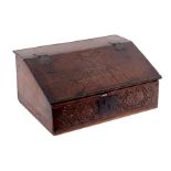 An 18th Century oak Bible box with carved front, the cover initialled DW and dated 1690,