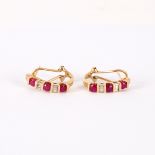 A pair of ruby and diamond half hoop earrings, set in 10k yellow gold,