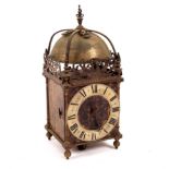 A 19th Century brass lantern type clock with bell to the strapwork top and pierced fretwork gallery,