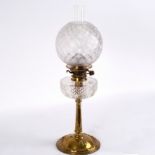 A brass and glass oil lamp with funnel, shade and reservoir in cut and moulded glass,