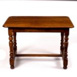 A 17th Century style walnut table on turned legs united by H stretcher,