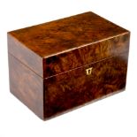 An early Victorian burr walnut tea caddy, fitted two domed hinged lidded compartments,