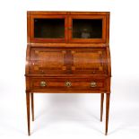 A Victorian walnut and inlaid cylinder writing desk, with a cupboard enclosed by glazed doors above,