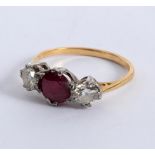 A ruby and diamond three-stone ring, claw set in white metal to a yellow metal shank,