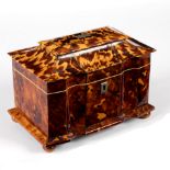 A Regency tortoiseshell tea caddy of sarcophagus form with shaped front, on bun feet,