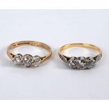 A diamond three-stone ring set in 18ct yellow gold, size J and another similar,