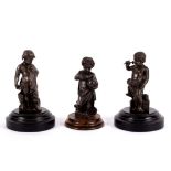 Three bronze figures of putti, perhaps emblematic of the Arts, each on a circular wooden plinth,