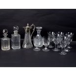 A cut glass decanter with silver collar, two other decanters,