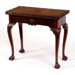 A George III mahogany tea table, the folding top carved flowers and bands,