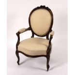 A Louis XV style rosewood fauteuil with floral carved oval back,