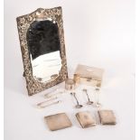 A silver framed mirror, with shaped glass and easel back (damaged), 35cm x 22cm,