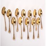 A closely matched set of twelve silver gilt dessert spoons, various dates and makers, crested,