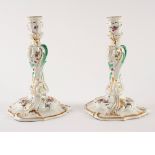 A pair of Meissen porcelain table candlesticks, leaf moulded and of baluster form,