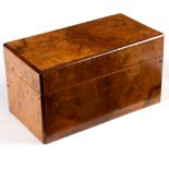 A Victorian walnut tea caddy enclosing two lidded compartments flanking a mixing bowl,