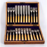 A set of twelve silver plated fish knives and forks, with silver collars and ivory handles,