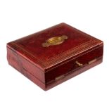 A Victorian red leather writing slope with carry handle to lid,