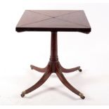 An Edwardian mahogany envelope card table on turned column and tripod support,