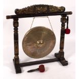 A gong in a carved and gilded stand,