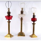 Three oil lamps, converted for electricity, each with brass column,