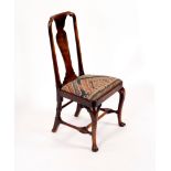 A George I walnut splat back chair on cabriole legs united by a stretcher