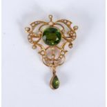 An Edwardian peridot and pearl pendant/brooch set in 15ct gold, 43mm long,