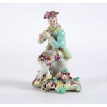 A Derby figure of a seated musician, circa 1760, wearing a turquoise coat,