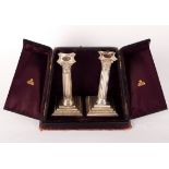 A pair of silver candlesticks, Martin & Hall, London, of Corinthian column form, 17cm high,