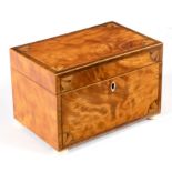 A George III satinwood tea caddy, with inlaid corner spandrels on ivory bun feet,