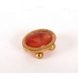 An intaglio carved oval carnelian, depicting a man in profile, oval,