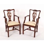 A pair of Georgian style open armchairs with splat backs and trap seats