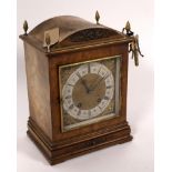 A German walnut cased mantel clock, the square dial with silvered chapter ring,