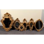 A gilt framed wall mirror of cartouche shape,