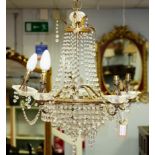 A five-branch chandelier hung with swags of prismatic drops,