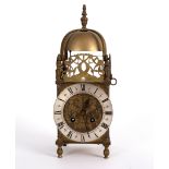 A 19th Century small lantern type mantel clock with pierced surround to the bell top,