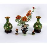 A pair of cloisonné vases, decorated birds and prunus branches to a green ground, 23.