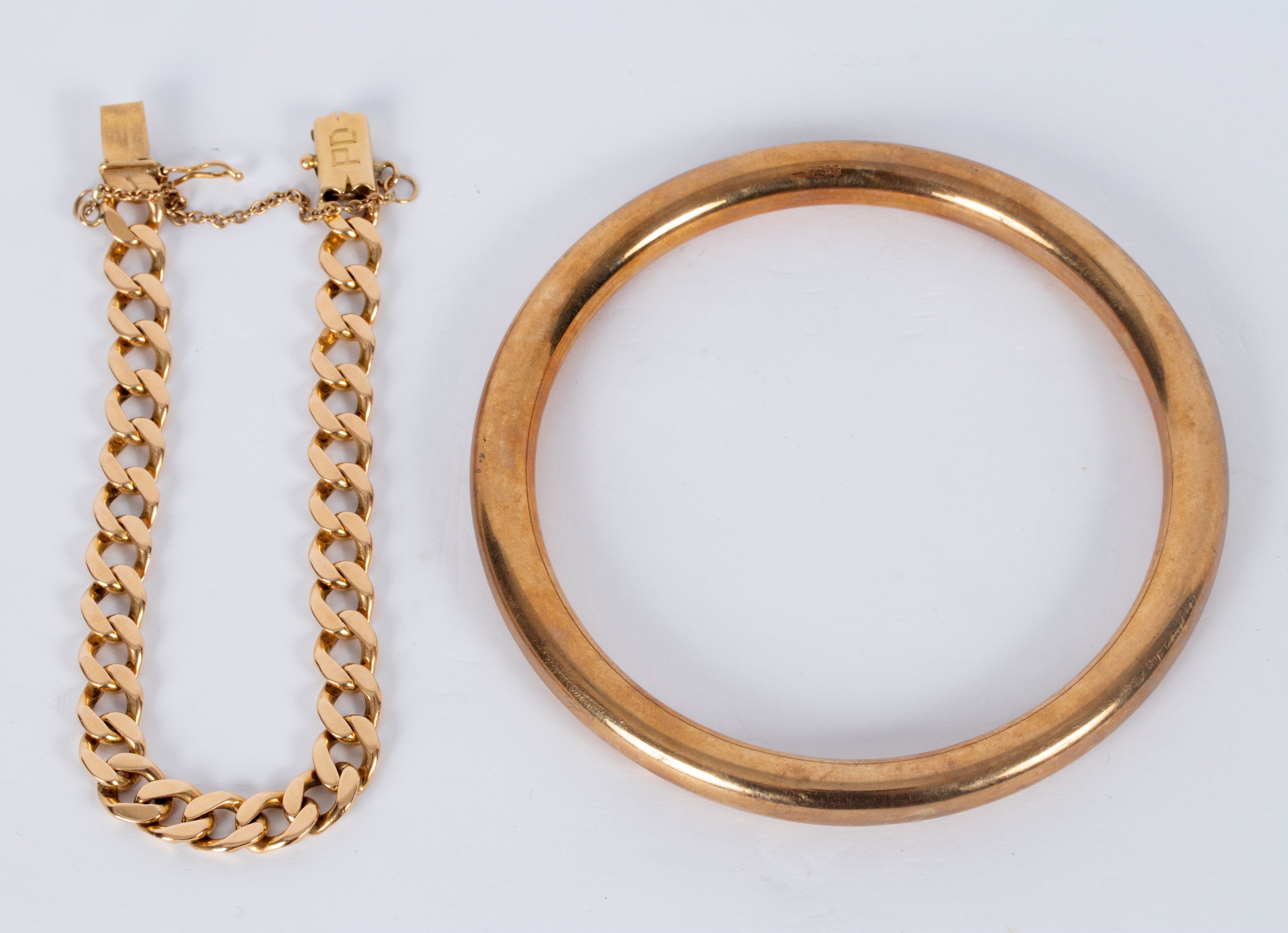A gold bracelet of flattened curb links and a circular bangle, Henry Griffith & Sons,