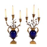 A pair of blue glass and gilt metal mounted table candelabra,