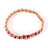 A ruby and diamond bracelet, set in 14k yellow gold,
