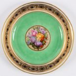 A Derby green ground cabinet plate painted a central roundel of flowers attributed to William