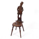 A carved oak chair of Charles Dickens interest, the back carved as Mr Micawber,