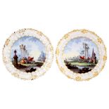 A pair of 18th Century French enamel plates with capriccio scenes of amorous couples,