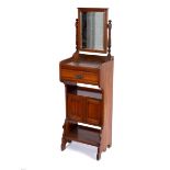 An Edwardian walnut shaving stand with mirror over, drawer and cupboard beneath,