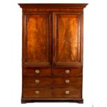 A Regency mahogany linen press, fitted sliding trays enclosed by a pair of fielded panel doors,