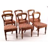 A set of six Victorian mahogany balloon back dining chairs with upholstered seats on turned front