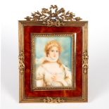 Continental School/ Portrait Miniature of a young woman/in a gilt metal frame and fitted leather
